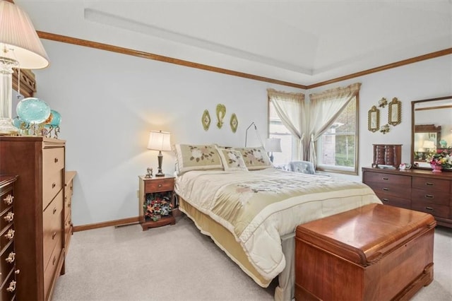 bedroom with light colored carpet, baseboards, crown molding, and a tray ceiling