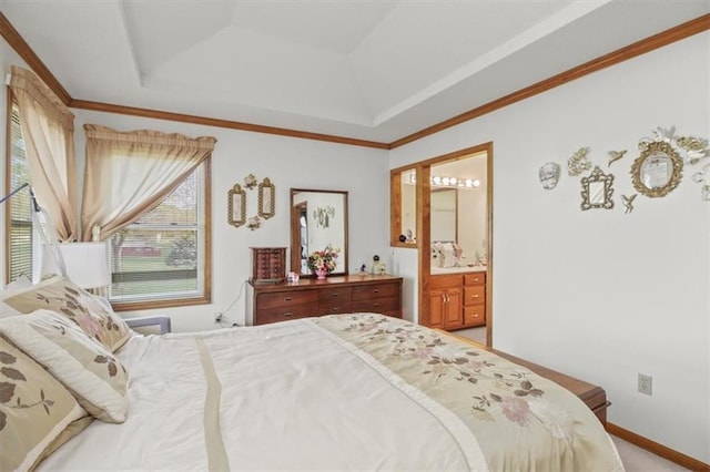 bedroom with light colored carpet, baseboards, ensuite bath, and a raised ceiling