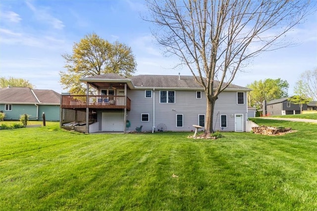 back of house featuring a yard, a ceiling fan, and a deck