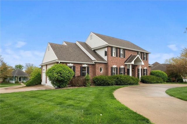 view of front of home featuring a garage, curved driveway, a front yard, and brick siding
