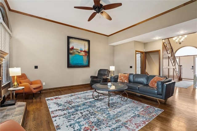 living room with crown molding, baseboards, ceiling fan, and wood finished floors