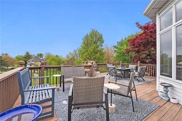 deck with outdoor dining area and a grill