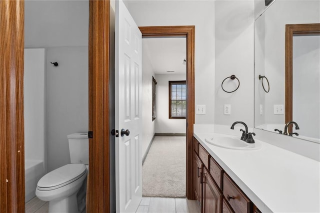 full bathroom featuring vanity, baseboards, and toilet