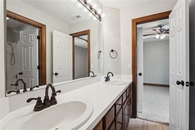 full bath featuring a sink, a ceiling fan, double vanity, and visible vents