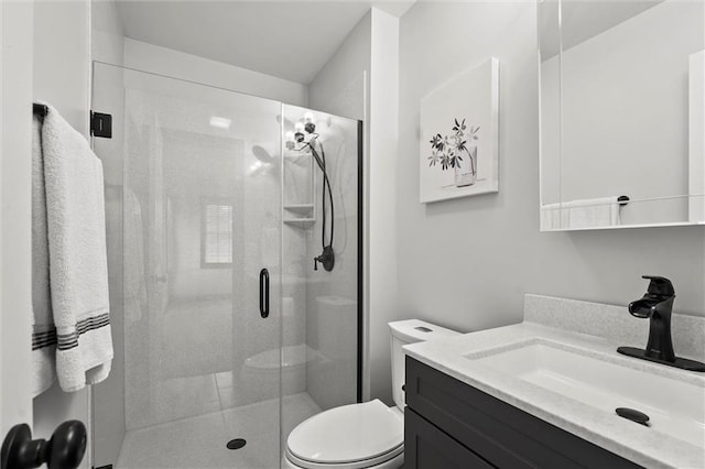 full bath with vanity, a stall shower, and toilet