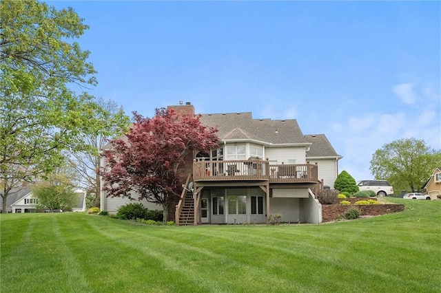 back of property with a lawn, a wooden deck, stairs, and a chimney