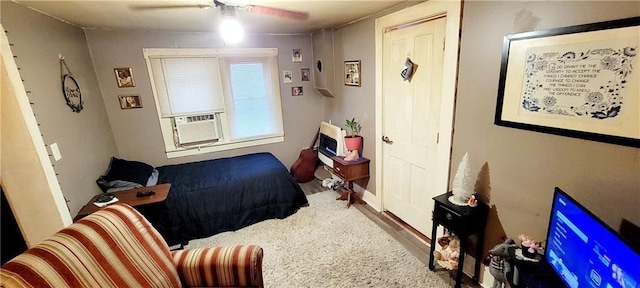 124 W 3rd Ave, Garnett, KS 66032 - bedroom with baseboards, a ceiling fan, wood finished floors, and cooling unit