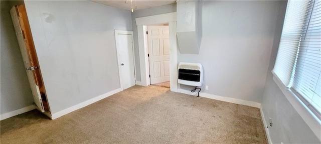 124 W 3rd Ave, Garnett, KS 66032 - empty room with carpet floors, heating unit, and plenty of natural light