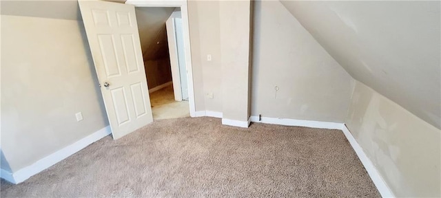 124 W 3rd Ave, Garnett, KS 66032 - additional living space featuring lofted ceiling, carpet flooring, and baseboards