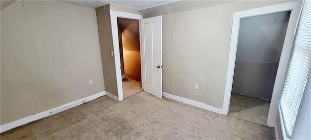 124 W 3rd Ave, Garnett, KS 66032 - unfurnished bedroom featuring wooden walls, carpet, and baseboards