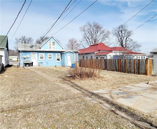 124 W 3rd Ave, Garnett, KS 66032 - back of property with fence, an outbuilding, and a storage shed