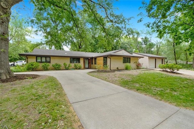 1804 Kenmar Dr, Manhattan, KS 66502 - single story home with concrete driveway, a garage, and a front lawn