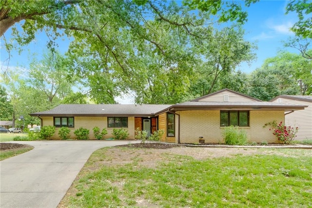 1804 Kenmar Dr, Manhattan, KS 66502 - view of front facade featuring concrete driveway, brick siding, and a front yard