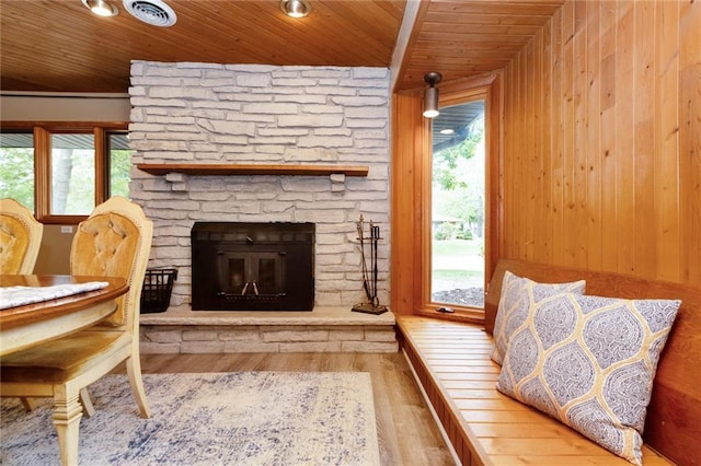 1804 Kenmar Dr, Manhattan, KS 66502 - living room with wood finished floors, healthy amount of natural light, wood ceiling, a stone fireplace, and wood walls