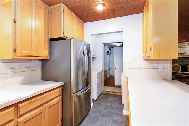 1804 Kenmar Dr, Manhattan, KS 66502 - kitchen with washer / dryer, wood ceiling, backsplash, light countertops, and freestanding refrigerator