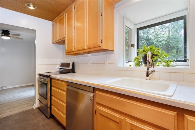 1804 Kenmar Dr, Manhattan, KS 66502 - kitchen featuring stainless steel appliances, a sink, light countertops, ceiling fan, and wooden ceiling