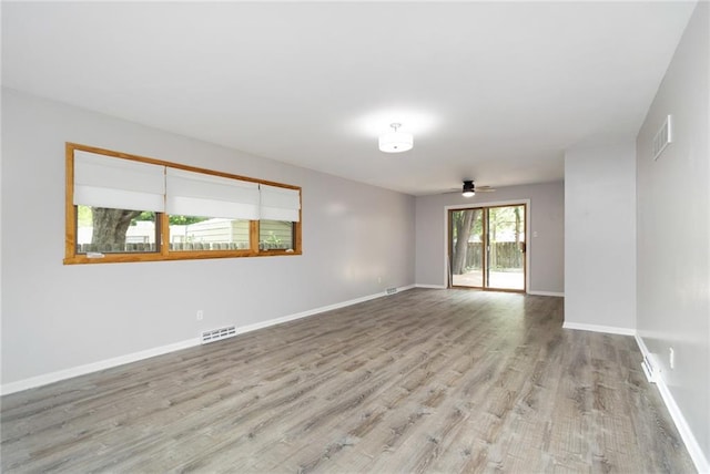 1804 Kenmar Dr, Manhattan, KS 66502 - spare room with wood finished floors, baseboards, and a ceiling fan