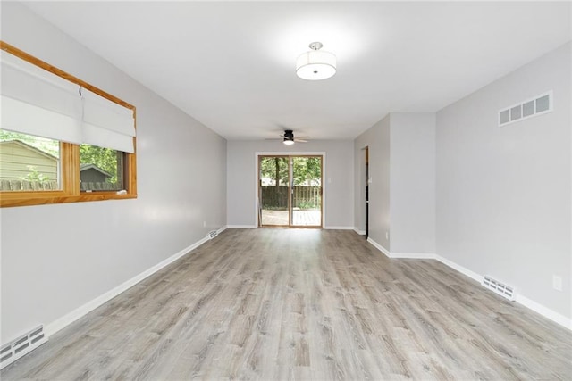 1804 Kenmar Dr, Manhattan, KS 66502 - spare room with light wood-style floors, ceiling fan, and baseboards