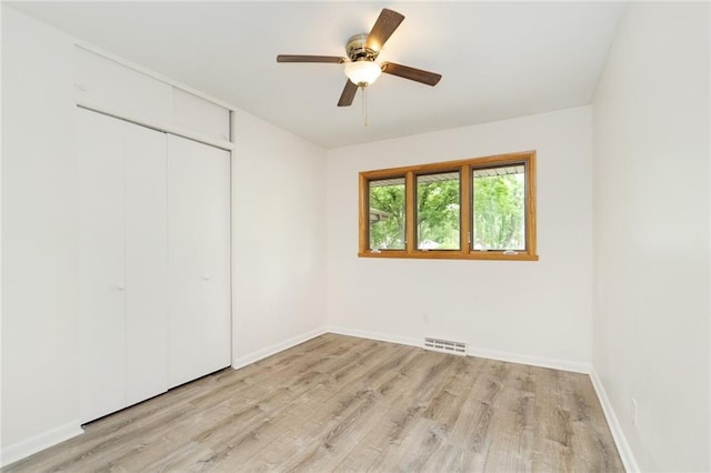 1804 Kenmar Dr, Manhattan, KS 66502 - unfurnished bedroom with light wood finished floors, a closet, baseboards, and ceiling fan