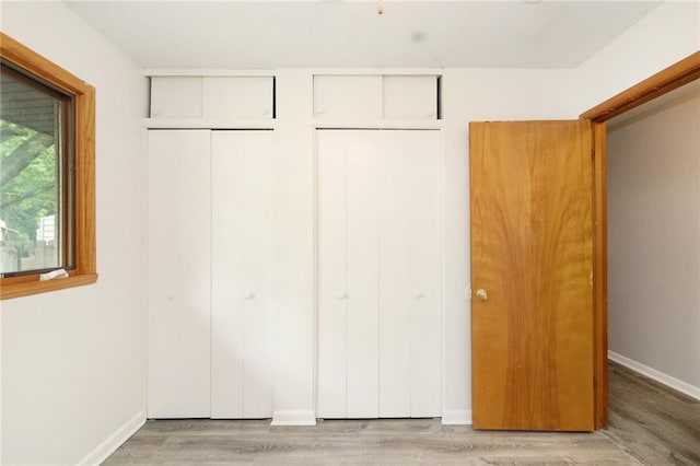 1804 Kenmar Dr, Manhattan, KS 66502 - unfurnished bedroom featuring a closet, light wood-style floors, and baseboards