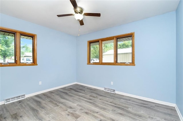 1804 Kenmar Dr, Manhattan, KS 66502 - unfurnished room with baseboards, wood finished floors, and a ceiling fan