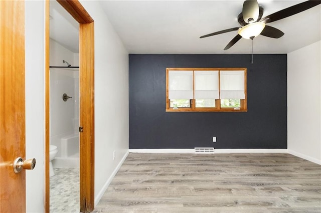 1804 Kenmar Dr, Manhattan, KS 66502 - spare room with wood finished floors, a ceiling fan, and baseboards