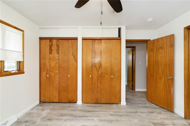1804 Kenmar Dr, Manhattan, KS 66502 - unfurnished bedroom with light wood-style flooring, two closets, and baseboards