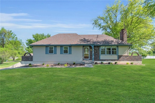 ranch-style house with a chimney, a front lawn, brick siding, and roof with shingles