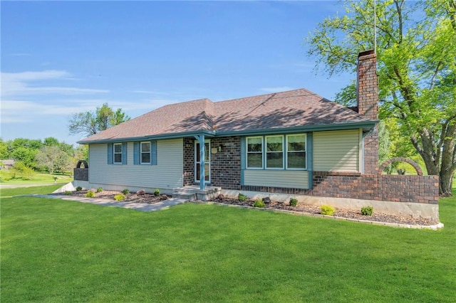 single story home featuring a chimney, a front lawn, and brick siding