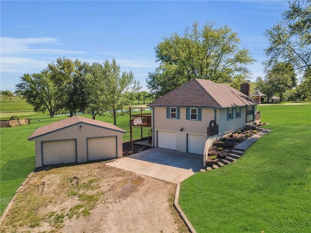 view of home's exterior featuring a lawn, a garage, a chimney, and an outdoor structure