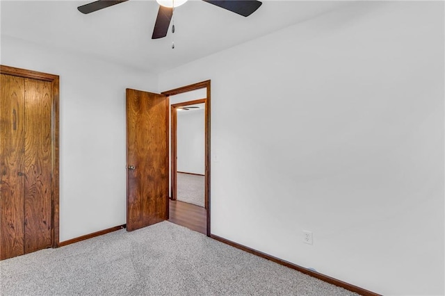 unfurnished bedroom with carpet floors, baseboards, and a ceiling fan