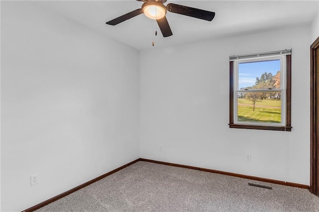 spare room featuring carpet floors, baseboards, and ceiling fan