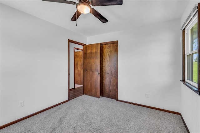 unfurnished bedroom with carpet floors, baseboards, and ceiling fan