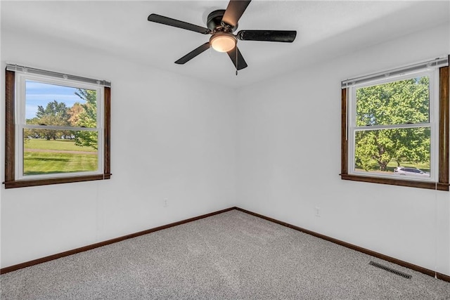carpeted spare room with baseboards and ceiling fan