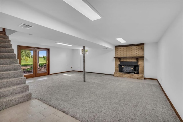 unfurnished living room with stairs, plenty of natural light, and baseboards
