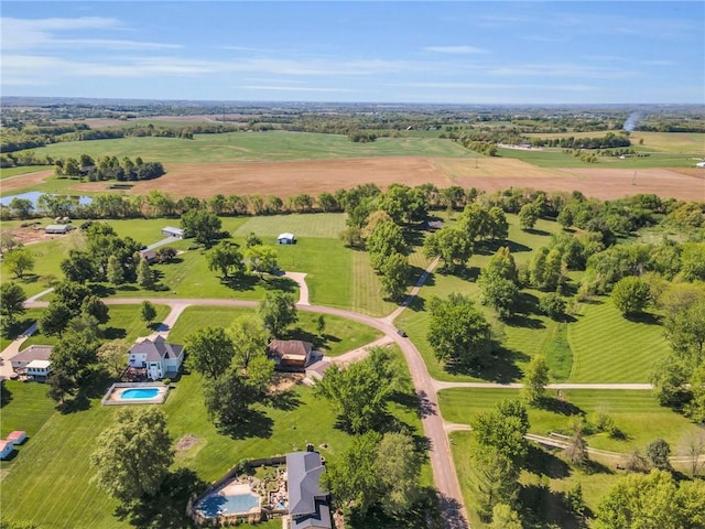 aerial view of sparsely populated area with a pool