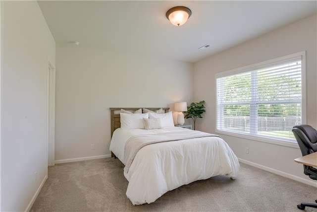 bedroom featuring baseboards and light carpet