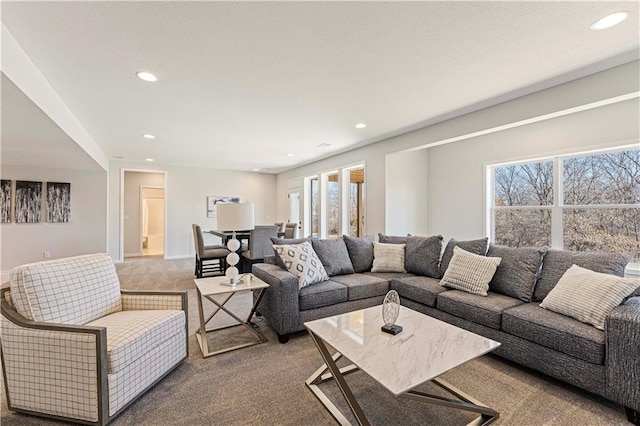 carpeted living room featuring recessed lighting and baseboards