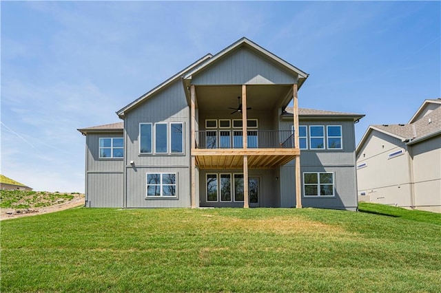 back of house with a yard, a ceiling fan, and a balcony