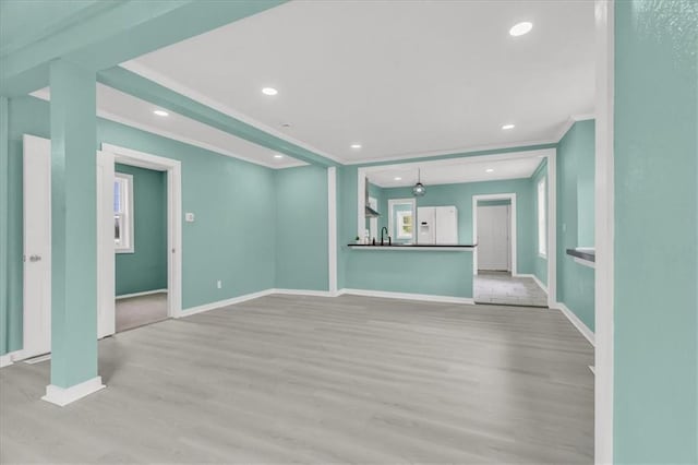 2723 Kimball Ave, Kansas City, KS 66104 - unfurnished living room featuring crown molding, recessed lighting, wood finished floors, and baseboards