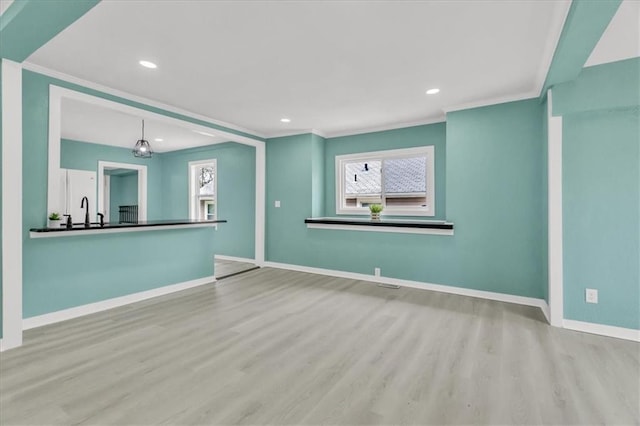 2723 Kimball Ave, Kansas City, KS 66104 - unfurnished living room with wood finished floors, recessed lighting, ornamental molding, and baseboards