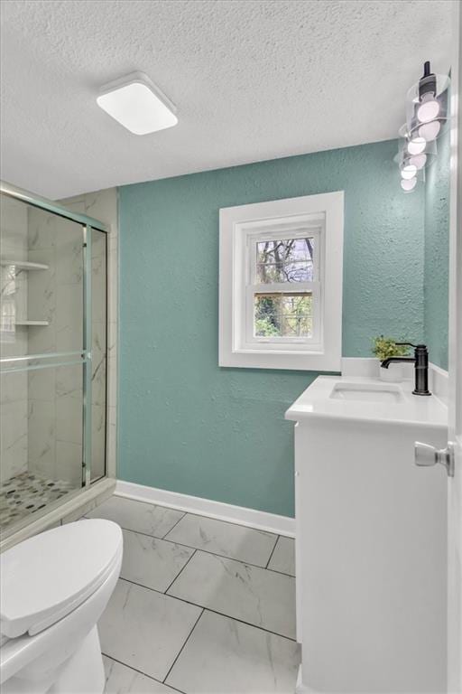 2723 Kimball Ave, Kansas City, KS 66104 - bathroom with a textured ceiling, a stall shower, baseboards, toilet, and vanity