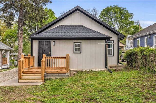 2723 Kimball Ave, Kansas City, KS 66104 - rear view of property with roof with shingles, a deck, and a yard
