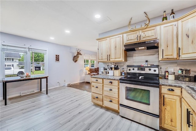 312 W Pine St, Butler, MO 64730 - kitchen featuring under cabinet range hood, electric range, light brown cabinets, light wood-type flooring, and decorative backsplash