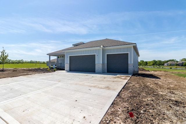garage featuring concrete driveway
