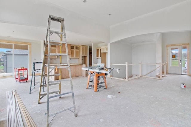 game room with plenty of natural light and arched walkways