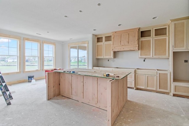 kitchen featuring a center island and light brown cabinetry