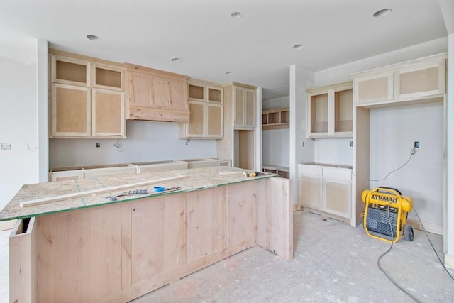 kitchen with light brown cabinets and a kitchen island