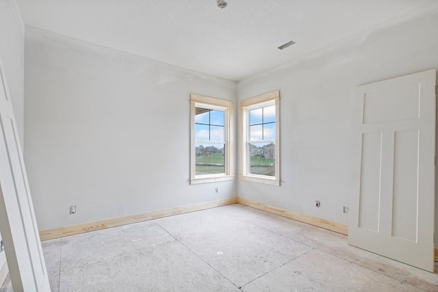 spare room featuring baseboards