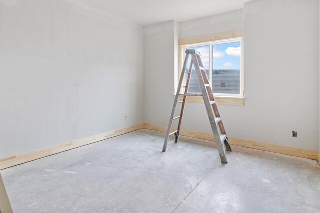 empty room featuring unfinished concrete flooring